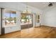 Bright, empty living room with hardwood floors, neutral paint, and a sliding glass door to the backyard at 9704 Brawley Dr, Las Vegas, NV 89134
