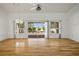 Spacious living room features hardwood floors, neutral paint, a ceiling fan, and access to the backyard at 9704 Brawley Dr, Las Vegas, NV 89134