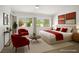 Staged bedroom with a king bed, stylish decor, and large windows offering outdoor views at 9704 Brawley Dr, Las Vegas, NV 89134