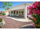 Covered patio with ample space for outdoor seating and entertaining, surrounded by lush landscaping at 9704 Brawley Dr, Las Vegas, NV 89134