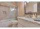 Clean bathroom features a granite countertop and shower-tub combo with glass door at 10243 Songsparrow Ct, Las Vegas, NV 89135