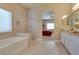 Serene bathroom with tub, shower, vanity and open access to the main bedroom at 10243 Songsparrow Ct, Las Vegas, NV 89135