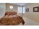 Bedroom with ample natural light, iron bed frame, and unique circular window at 10243 Songsparrow Ct, Las Vegas, NV 89135