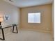 Tan bedroom with a desk, neutral walls, and natural light from window at 10243 Songsparrow Ct, Las Vegas, NV 89135