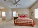 Comfortable bedroom with ceiling fan, window, and ensuite bathroom access at 10243 Songsparrow Ct, Las Vegas, NV 89135