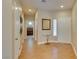 Bright foyer with hardwood floors, glass table, and view into adjacent bedroom at 10243 Songsparrow Ct, Las Vegas, NV 89135