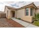 Inviting home exterior featuring a covered entryway and attractive desert landscaping at 10243 Songsparrow Ct, Las Vegas, NV 89135