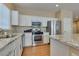 Well-lit kitchen featuring stainless steel appliances and light granite countertops at 10243 Songsparrow Ct, Las Vegas, NV 89135