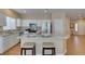 Bright, modern kitchen with stainless steel appliances and bar stool seating at the island at 10243 Songsparrow Ct, Las Vegas, NV 89135