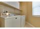 Functional laundry room with a side-by-side washer and dryer at 10243 Songsparrow Ct, Las Vegas, NV 89135