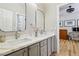 Stylish bathroom with dual vanity, framed mirrors, and white marble countertops at 10381 Borah Park Cir, Las Vegas, NV 89178