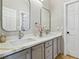 Elegant bathroom with dual sinks, marble countertops, and modern fixtures at 10381 Borah Park Cir, Las Vegas, NV 89178