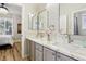 Elegant bathroom with dual vanity, framed mirrors, and white marble countertops at 10381 Borah Park Cir, Las Vegas, NV 89178