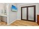Bedroom featuring wood floors, a wall-mounted TV, and an ensuite bathroom at 10381 Borah Park Cir, Las Vegas, NV 89178