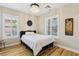 Comfortable bedroom with wood floors, plantation shutters, and a stylish chandelier at 10381 Borah Park Cir, Las Vegas, NV 89178