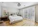 Spacious bedroom featuring shutters, hardwood floors, and ample natural light at 10381 Borah Park Cir, Las Vegas, NV 89178