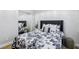 Well-lit bedroom with a mirrored closet, wood floors, and chic black and white accents at 10381 Borah Park Cir, Las Vegas, NV 89178
