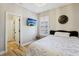 Cozy bedroom with an elegant chandelier, shutters, and a wall-mounted TV at 10381 Borah Park Cir, Las Vegas, NV 89178