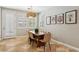 Bright dining room with tile flooring, shuttered windows, modern chandelier, and stylish dining set at 10381 Borah Park Cir, Las Vegas, NV 89178