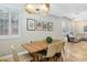Dining room featuring a modern table and chairs, decorative lighting and shuttered windows at 10381 Borah Park Cir, Las Vegas, NV 89178