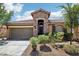 Charming single-story home featuring a stone facade, two-car garage, and drought-tolerant landscaping at 10381 Borah Park Cir, Las Vegas, NV 89178