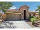 Charming single-story home featuring a stone facade, two-car garage, and drought-tolerant landscaping at 10381 Borah Park Cir, Las Vegas, NV 89178