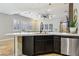 Modern kitchen featuring a breakfast bar, sleek black cabinets, and stainless steel appliances at 10381 Borah Park Cir, Las Vegas, NV 89178