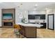 Open-concept kitchen featuring modern finishes, including stainless steel appliances, quartz countertops, and a central island at 10381 Borah Park Cir, Las Vegas, NV 89178