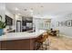 Modern kitchen with dark cabinets, quartz countertops, stainless steel appliances and a dining area at 10381 Borah Park Cir, Las Vegas, NV 89178