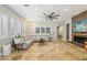 Spacious living room featuring tile floors, large windows with shutters, and a comfortable sectional sofa at 10381 Borah Park Cir, Las Vegas, NV 89178
