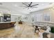 Bright and airy living room with tile flooring, modern lighting, plantation shutters, and stylish decor at 10381 Borah Park Cir, Las Vegas, NV 89178