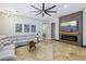 Cozy living room with modern decor, tile flooring, a fireplace, and a comfortable sectional sofa at 10381 Borah Park Cir, Las Vegas, NV 89178