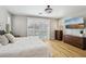 This is a main bedroom with wood flooring, a large glass sliding door, and plantation shutters at 10381 Borah Park Cir, Las Vegas, NV 89178