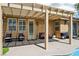 Inviting covered patio features modern furniture and string lights, perfect for outdoor relaxation and entertaining at 10381 Borah Park Cir, Las Vegas, NV 89178