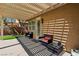 Covered patio with comfortable seating, overlooking a well-manicured lawn and mature trees at 10381 Borah Park Cir, Las Vegas, NV 89178