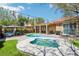 Serene backyard featuring a pool, spa, gazebo, covered patio, and green lawn at 10381 Borah Park Cir, Las Vegas, NV 89178