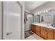 Bathroom includes a double sink vanity with granite counters and a large mirror with Hollywood lights at 105 Lighthouse Dr # 105, Boulder City, NV 89005
