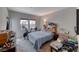 Bedroom with two windows, a bed, wood headboard, and a desk with various objects at 105 Lighthouse Dr # 105, Boulder City, NV 89005