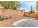 A backyard featuring a gravel ground cover, brick walls, and a concrete pad at 11016 Meadow Leaf Ave, Las Vegas, NV 89144