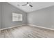 Clean, minimalist bedroom with gray walls, wood-look floors, and natural light, ready for personal touches at 11016 Meadow Leaf Ave, Las Vegas, NV 89144