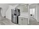 Well-lit kitchen adjacent to a laundry room has stainless steel appliances and light woodgrain floors at 11016 Meadow Leaf Ave, Las Vegas, NV 89144