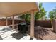 Private backyard featuring a covered patio and low-maintenance desert landscaping, perfect for outdoor entertaining at 11147 Verismo St, Las Vegas, NV 89141