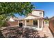 Home's backyard with mature trees, brick wall, covered patio, and gravel at 11147 Verismo St, Las Vegas, NV 89141