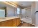 Bathroom featuring double sink vanity, a tub shower combo with glass door, and modern fixtures at 11147 Verismo St, Las Vegas, NV 89141
