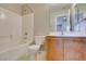 Bathroom features a tub-shower combo, tile surround, and vanity with wooden cabinets at 11147 Verismo St, Las Vegas, NV 89141
