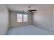 Carpeted bedroom features neutral walls, ceiling fan, and large window for ample natural light at 11147 Verismo St, Las Vegas, NV 89141