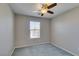 Cozy bedroom with plush carpet, ceiling fan, and natural light from a window at 11147 Verismo St, Las Vegas, NV 89141
