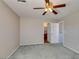 Bedroom with closet, neutral walls, carpet, ceiling fan and an open doorway at 11147 Verismo St, Las Vegas, NV 89141