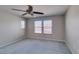 Spacious bedroom featuring ceiling fan, neutral walls, carpet, and large windows at 11147 Verismo St, Las Vegas, NV 89141