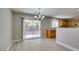 Dining area with backyard views, wood-look floors, and access to kitchen and outdoor living space at 11147 Verismo St, Las Vegas, NV 89141